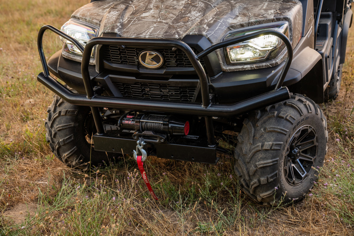 The front of a camouflage Kubota RTV-X utility vehicle: its brush guard and winch, close up