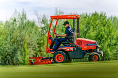 Kubota F2510 front-mount mower with a sun canopy, mowing a golf course