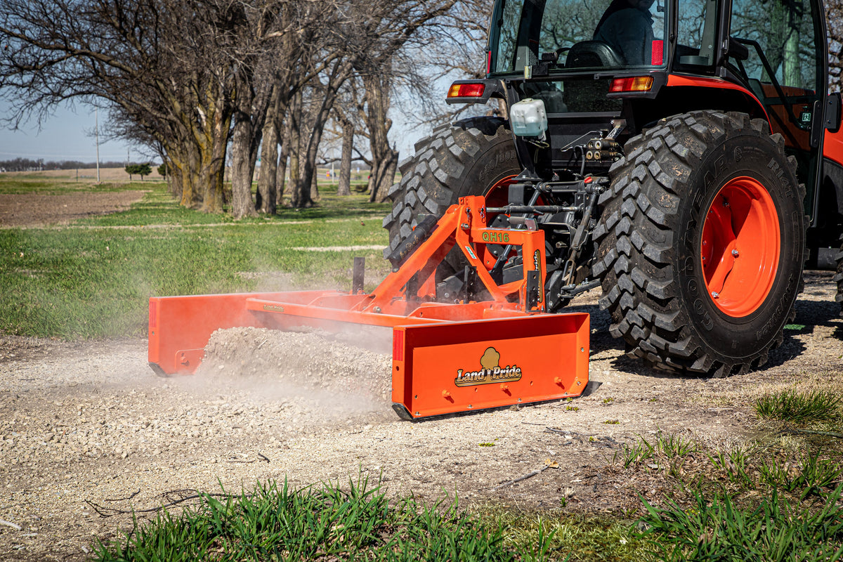Land Pride GS15 series grading scraper on a Land Pride QH16 quick hitch, grading gravel behind a Kubota tractor, close up