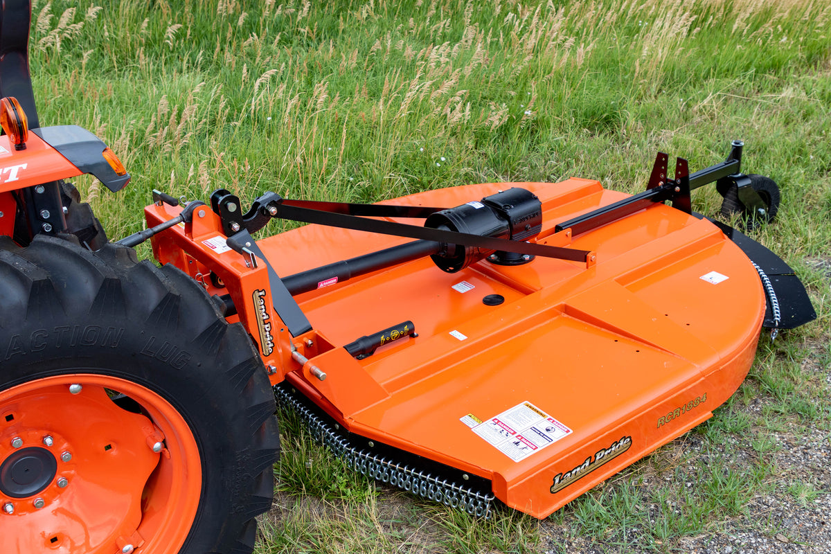 The deck and gearbox of a Land Pride RCR1884 rotary cutter on a Kubota tractor, close up