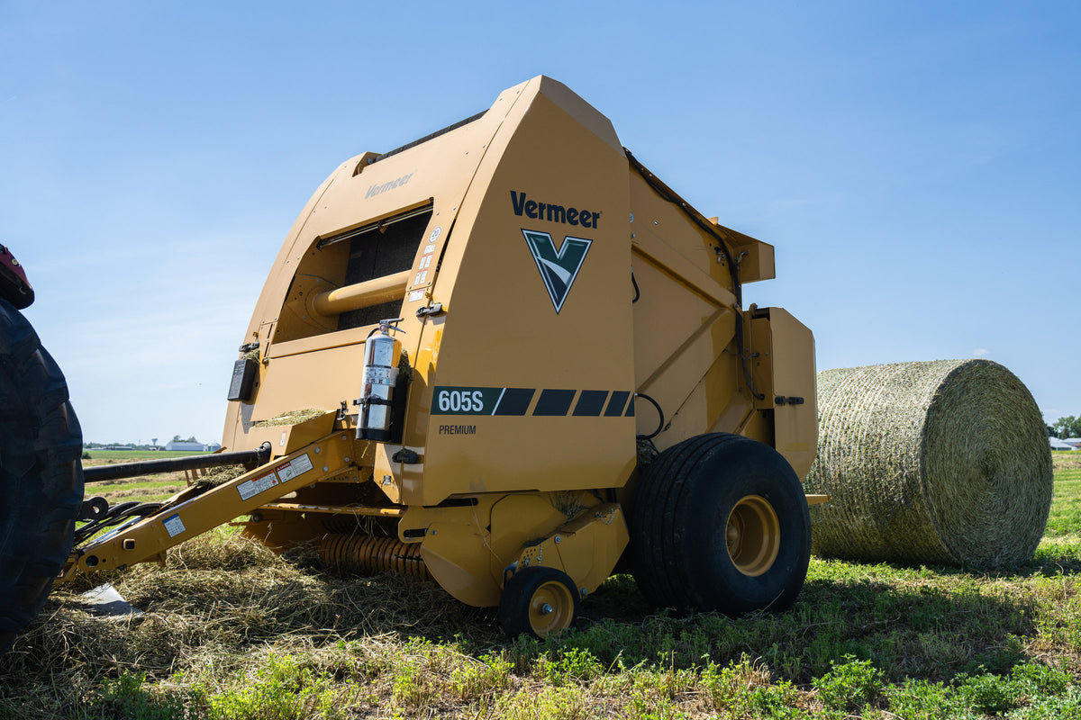 Vermeer 605S Premium round baler beside a finished bale