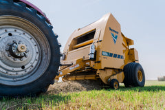 Vermeer 605S Rancher round baler baling hay, low angle