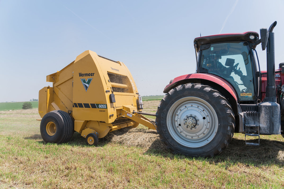 Vermeer 605S Rancher round baler baling hay, side view
