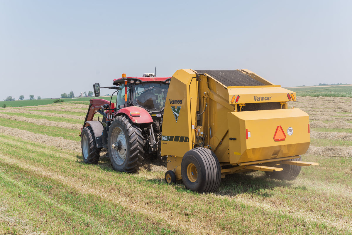 Vermeer 605S Rancher round baler in the field, rear view