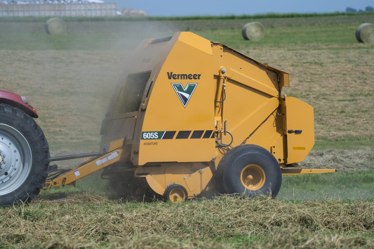 Vermeer 605S Signature round baler working in a hay field