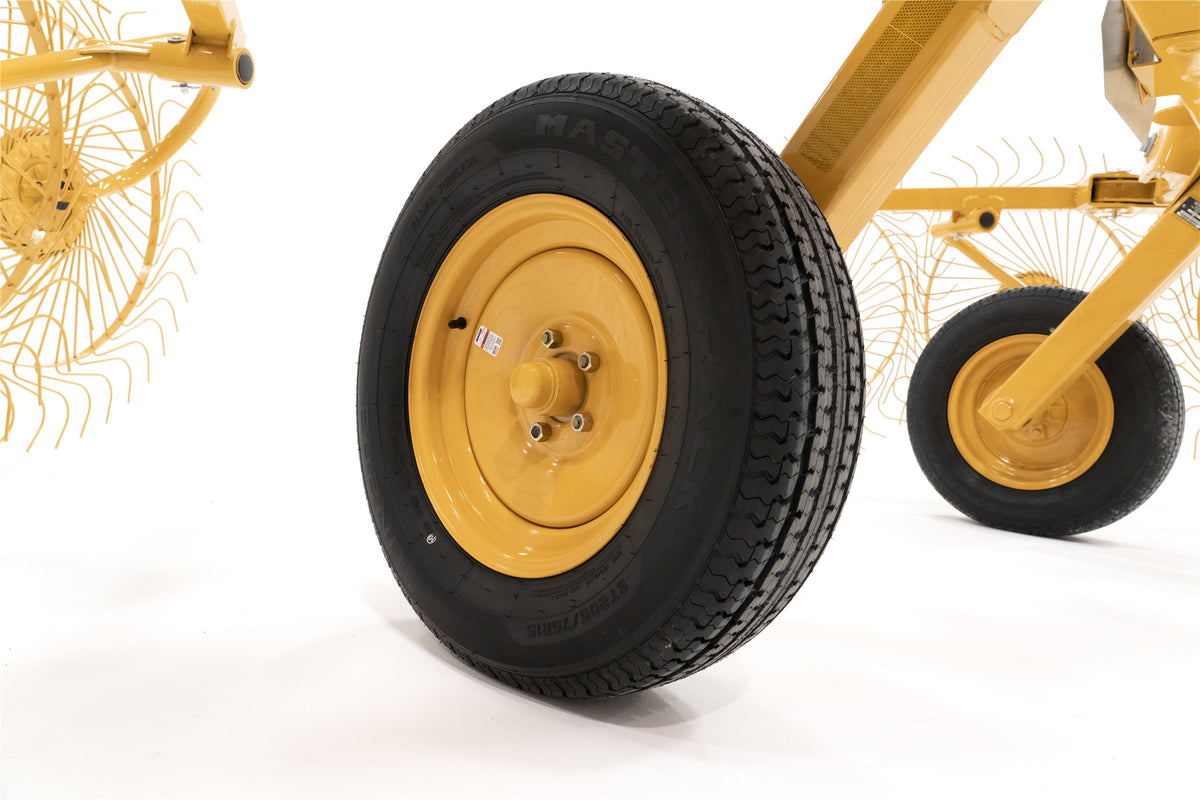 Close-up of a VRC1022 transport tire on its yellow wheel, with a smaller wheel behind it