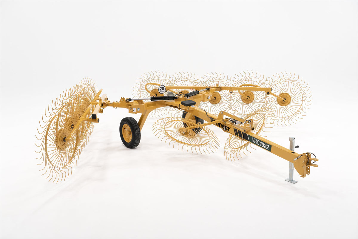 Vermeer VRC1022 carted wheel rake on a white background, seen from the front quarter, its ten rake wheels set for raking