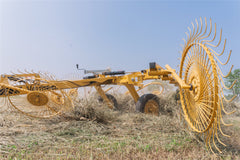 Vermeer VRC1022 carted wheel rake raking hay in a field