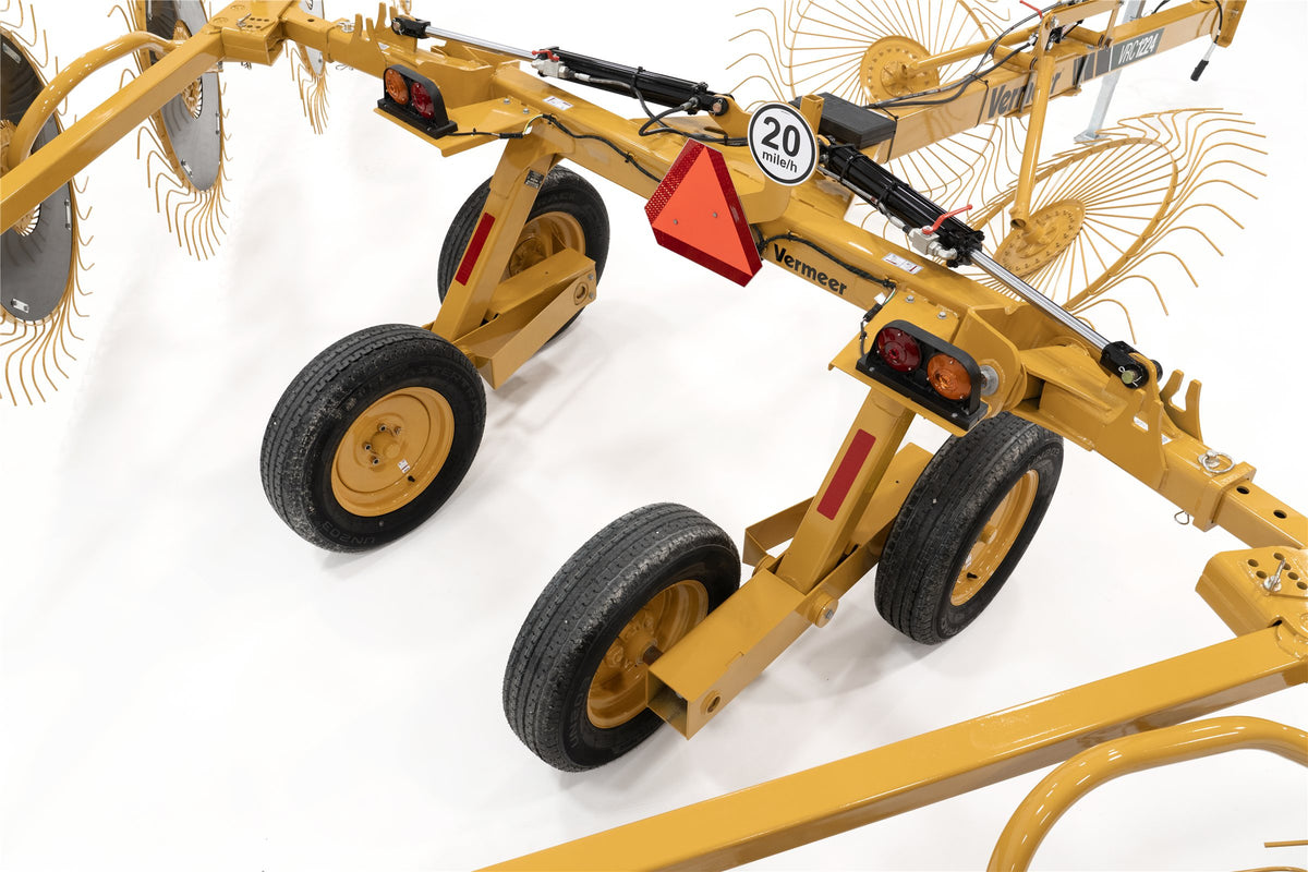 The VRC1224's cart from above, with four transport wheels, tail lights, a slow-moving-vehicle sign and a 20 mph sign