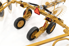 The VRC1224's cart from above, with four transport wheels, tail lights, a slow-moving-vehicle sign and a 20 mph sign