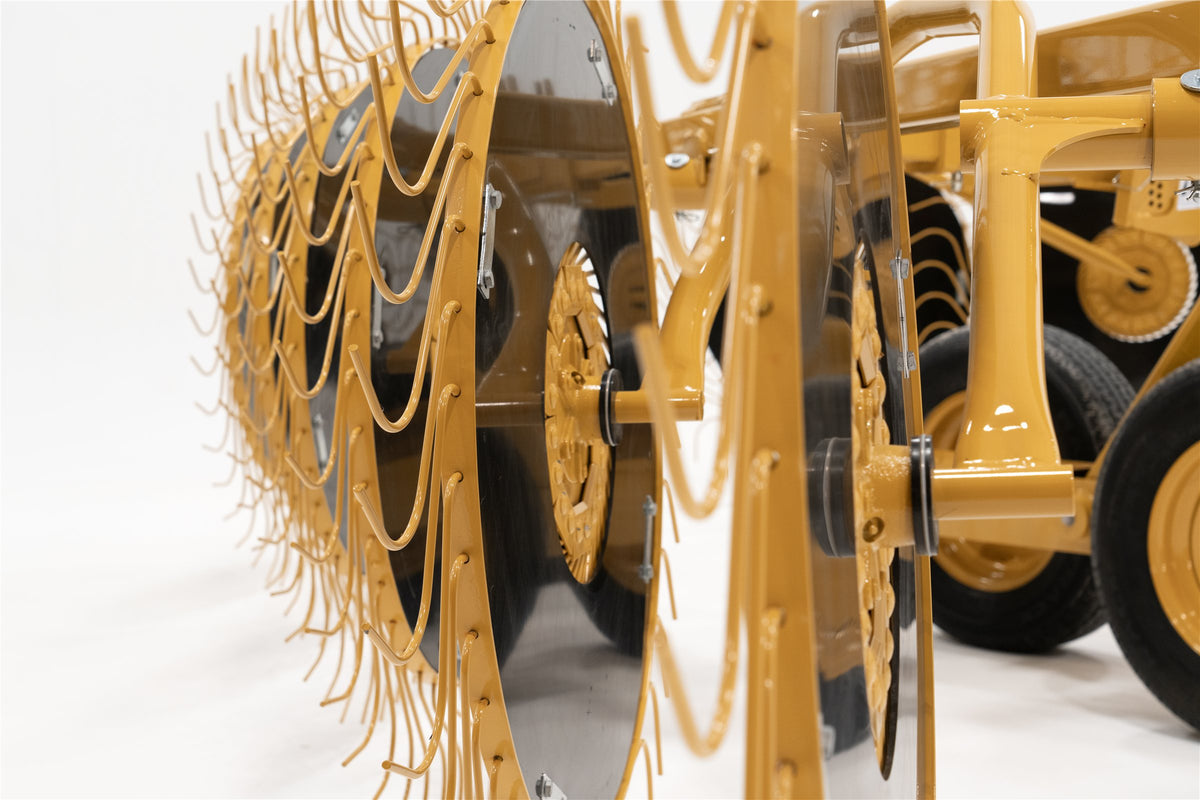 Close-up of the VRC1224's rake wheels, tines and wind discs, seen end-on