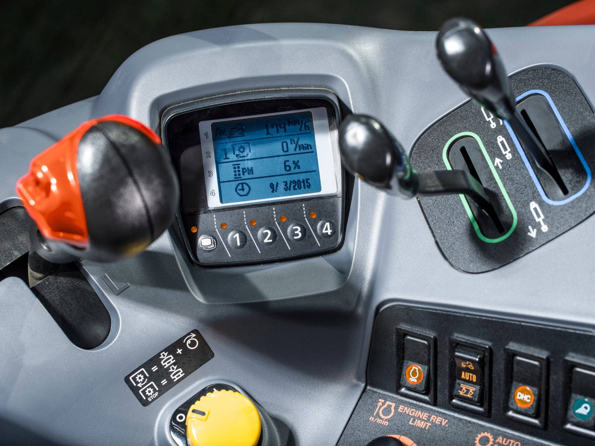 The armrest controls and display in a Kubota M6 tractor cab, close up