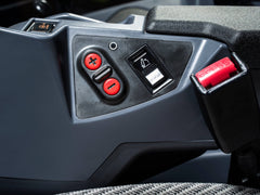 Shift buttons and a switch beside the seat in a Kubota M6 tractor cab, close up
