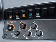 Engine rev limit, auto sensitivity and hitch dials in a Kubota M6 tractor cab, close up