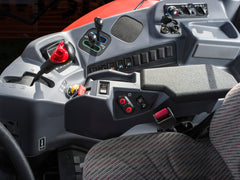 The right-hand console of a Kubota M6 tractor cab: the shift lever, hitch controls and switches