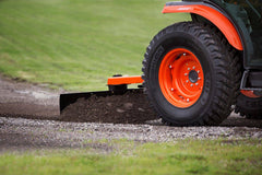 Land Pride RB16 series rear blade spreading gravel behind a Kubota tractor, close up