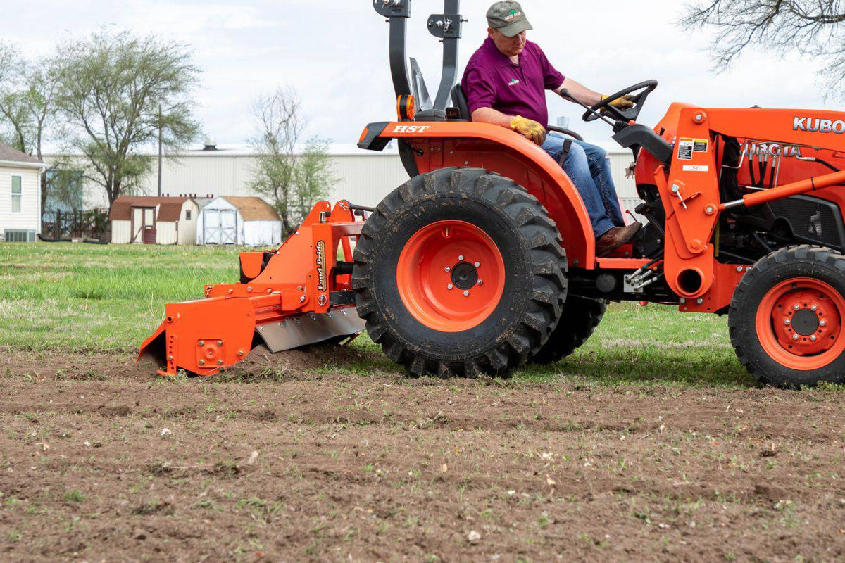 Land Pride RTR12 series rotary tiller working behind a Kubota compact tractor, close up