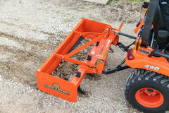 Land Pride BB12 series box scraper on a Land Pride QH05 quick hitch behind a Kubota sub-compact tractor, grading gravel, close up