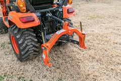 A Land Pride QH05 quick hitch on the 3-point hitch of a Kubota sub-compact tractor, seen from above